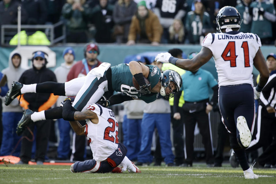 Philadelphia Eagles' Zach Ertz (86) is tackled by Houston Texans' Aaron Colvin (22) as Zach Cunningham (41) runs in during the first half of an NFL football game, Sunday, Dec. 23, 2018, in Philadelphia. (AP Photo/Matt Rourke)