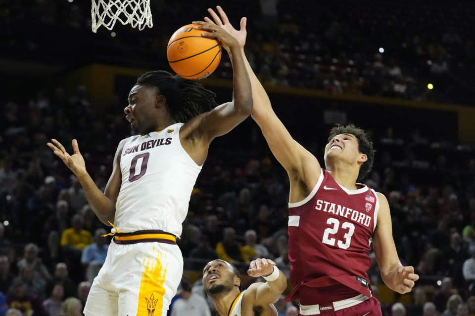 Arizona State guard Kamari Lands (0) grabs a reound against Stanford forward Brandon Angel (23) during the first half of an NCAA college basketball game Thursday, Feb. 1, 2024, in Tempe, Ariz. (AP Photo/Ross D. Franklin)