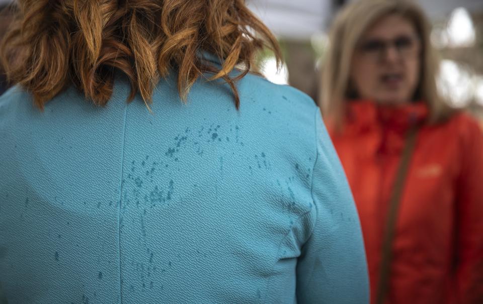 Rainwater settles on the blue blazer of Marathon County Director of Social Services Christa Jensen under a small tent outside Marathon County Courthouse on Thursday for the Marathon County Social Services' Hands Around the Courthouse observance acknowledging April as Strengthening Families Month. Attendees and speakers sported blue in support in raising awareness of Strengthening Families Month.