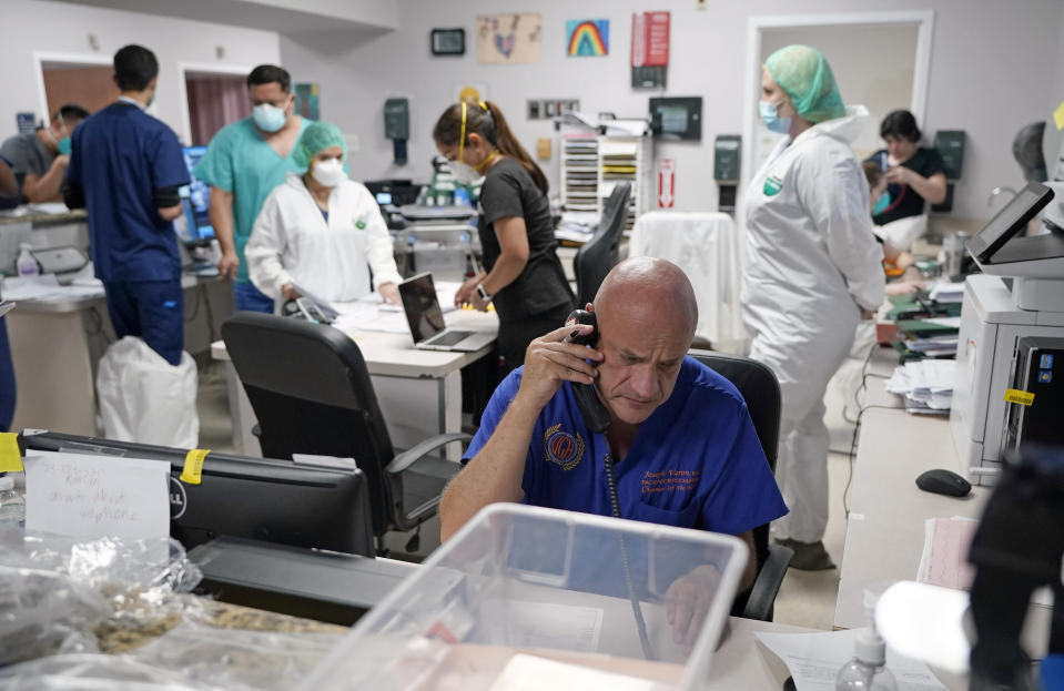 Dr. Joseph Varon notifies the family of a patient who died inside the Coronavirus Unit at United Memorial Medical Center, Monday, July 6, 2020, in Houston. Varon called the widow's daughter, expressing condolences first in Spanish, then English. He repeated that he had done everything he could and to call if there was anything she needed. When he hung up the phone, his bluish gray eyes were filled with tears. (AP Photo/David J. Phillip)