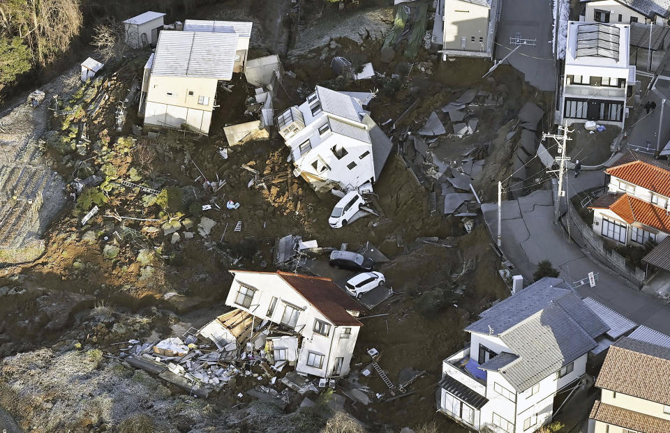 Houses leveled by an earthquake are seen in Kanazawa, Ishikawa prefecture, Japan Tuesday, Jan. 2, 2024. (Kyodo News via AP)