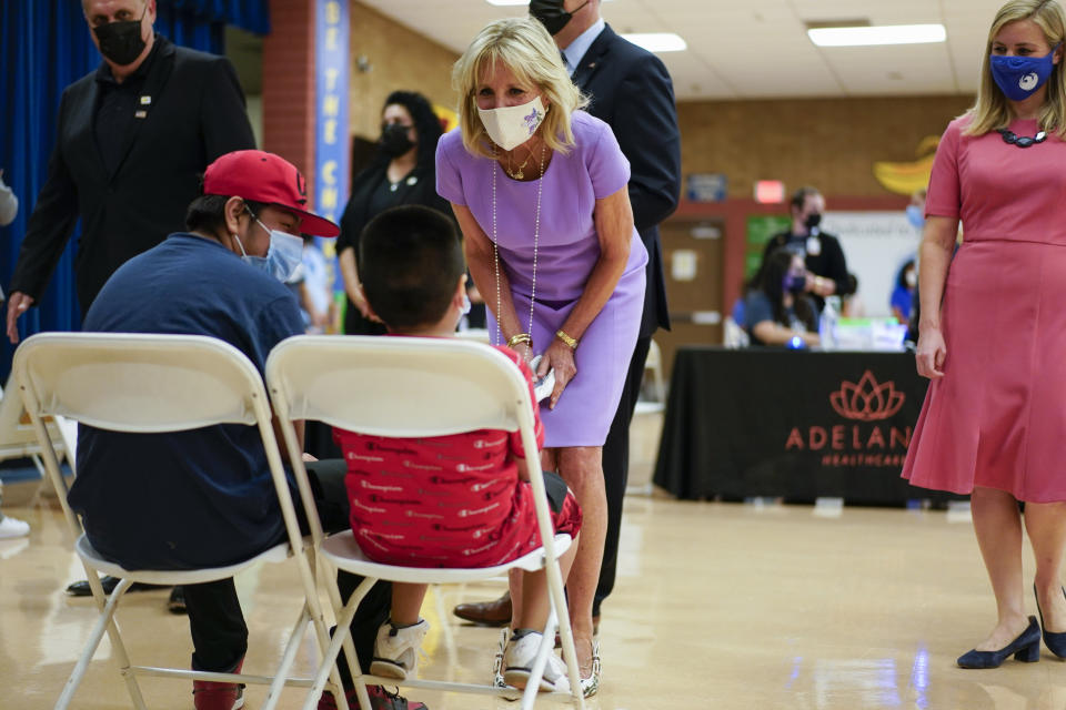 First lady Jill Biden speaks with people during a tour of a COVID-19 vaccination site at Isaac Middle School in Phoenix, Wednesday, June 30, 2021. Phoenix Mayor Kate Gallego is at right. (AP Photo/Carolyn Kaster, Pool)