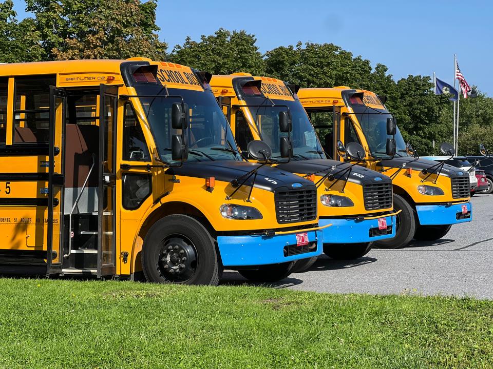 Three of South Burlington School District's electric buses are on display during a one year celebration of clean busing in the city on Aug. 28, 2023. The district has four electric school buses among its fleet of 28. One way to distinguish an electric bus is the blue bumper.