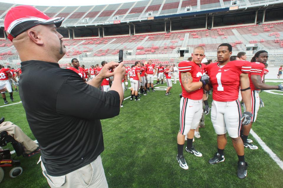 (NCL_OSUFOOTBALL10_LAURON 9AUG07) Ohio State football players James Laurinaitis and Marcus Freeman, 1, , right, pose for Laurinaitis' father, Joe, for the 2007-08 team photo during picture day at the Ohio Stadium, August 9, 2007. (Dispatch photo by Neal C. Lauron)