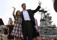 Paul Ryan waves with his daughter Liza as his wife Janna Little (2nd L) follows with their son Charlie (L) after Mitt Romney announced Ryan as his vice-presidential running mate during a campaign event at the battleship USS Wisconsin in Norfolk, Virginia August 11, 2012.