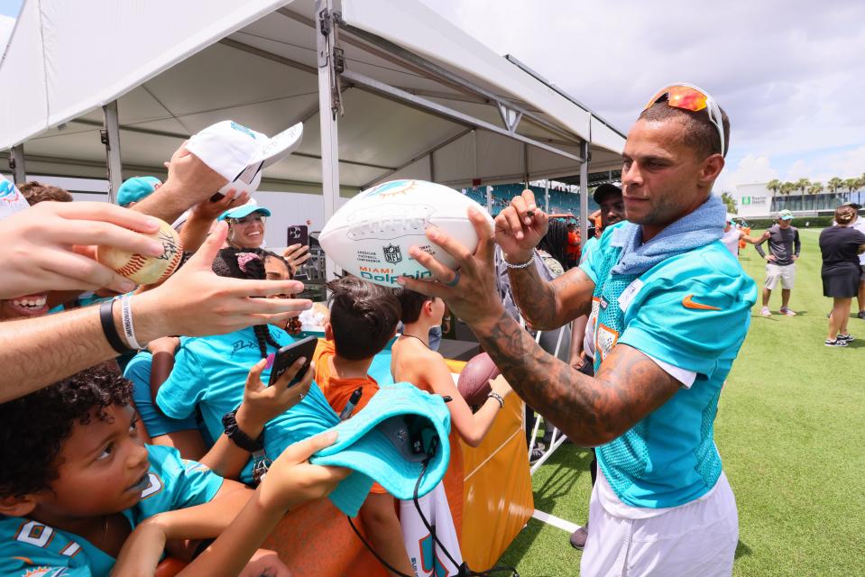 Jul 28, 2024; Miami Gardens, FL, USA; Miami Dolphins safety Jordan Poyer (21) signs autographs to fans during training camp at Baptist Health Training Complex. Mandatory Credit: Sam Navarro-USA TODAY Sports