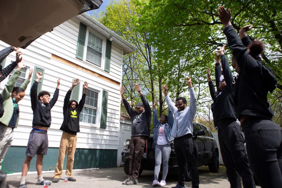 People’s Liberation Program members do breathing exercises before delivering for their free grocery event in Rochester, N.Y. on May 7, 2022.