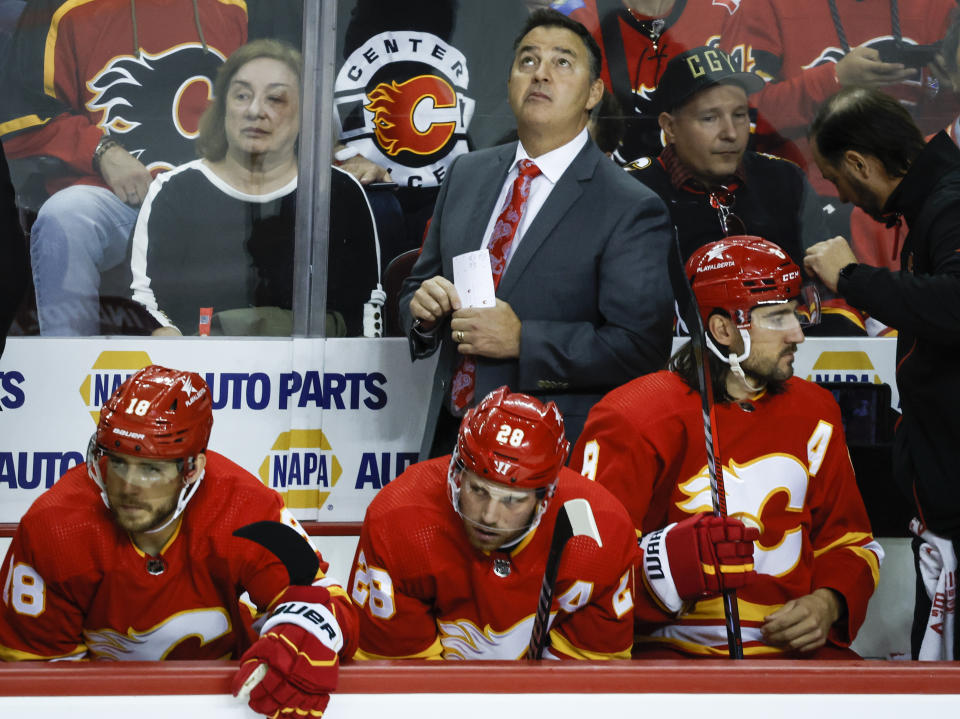 Calgary Flames assistant coach Dan Lamber looks to the scoreboard during the first period of the team's NHL hockey game against the Winnipeg Jets on Wednesday, Oct. 11, 2023, in Calgary, Alberta. (Jeff McIntosh/The Canadian Press via AP)