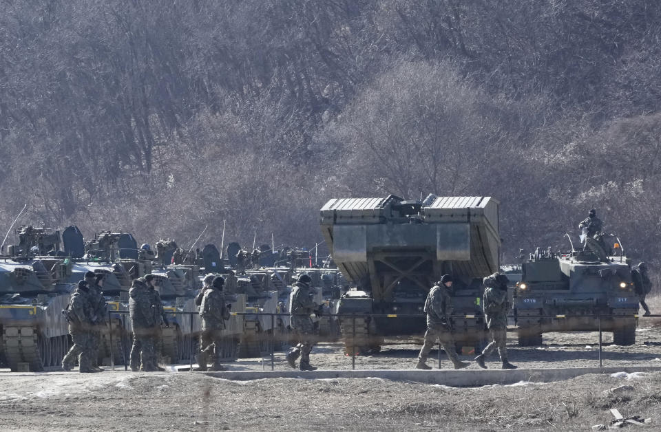 South Korean army soldiers pass by their armored vehicles during a military exercise in Paju, South Korea, near the border with North Korea, Wednesday, Jan. 24, 2024. South Korea's military says North Korea fired several cruise missiles into waters off its western coast, adding to a provocative run of weapons demonstrations in the face of deepening nuclear tensions with the United States, South Korea and Japan. (AP Photo/Ahn Young-joon)