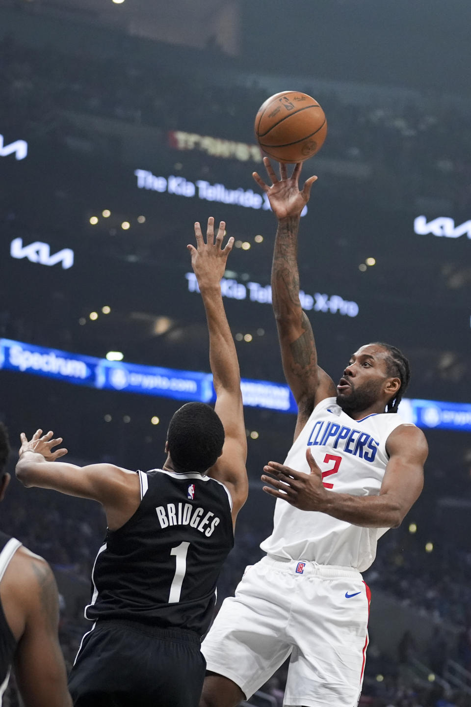 Los Angeles Clippers forward Kawhi Leonard (2) shoots over Brooklyn Nets forward Mikal Bridges (1) during the first half of an NBA basketball game Sunday, Jan. 21, 2024, in Los Angeles. (AP Photo/Marcio Jose Sanchez)