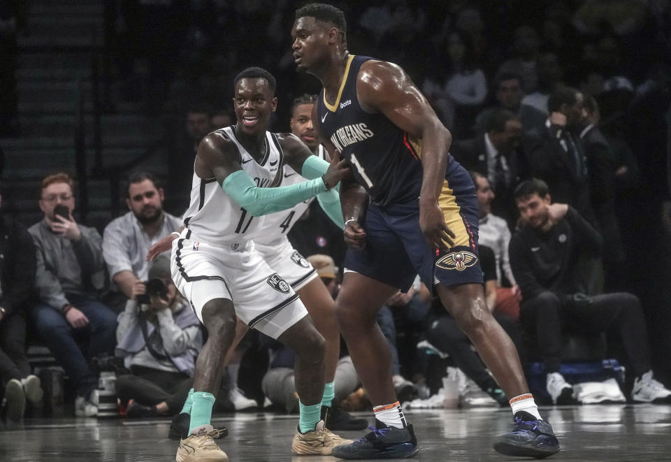 Brooklyn Nets' Dennis Schroder, left, pushes against New Orleans Pelicans' Zion Williamson during the first half of an NBA basketball game, Tuesday, March 19, 2024, in New York. (AP Photo/Bebeto Matthews)