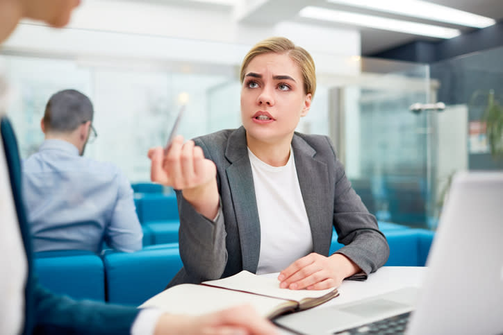 A financial planner reviewing with a colleague the requirements for different licenses. 