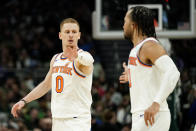 New York Knicks' Donte DiVincenzo (0) celebrates with Jalen Brunson, right, during the second half of an NBA basketball game against the Milwaukee Bucks, Sunday, April 7, 2024, in Milwaukee. (AP Photo/Aaron Gash)