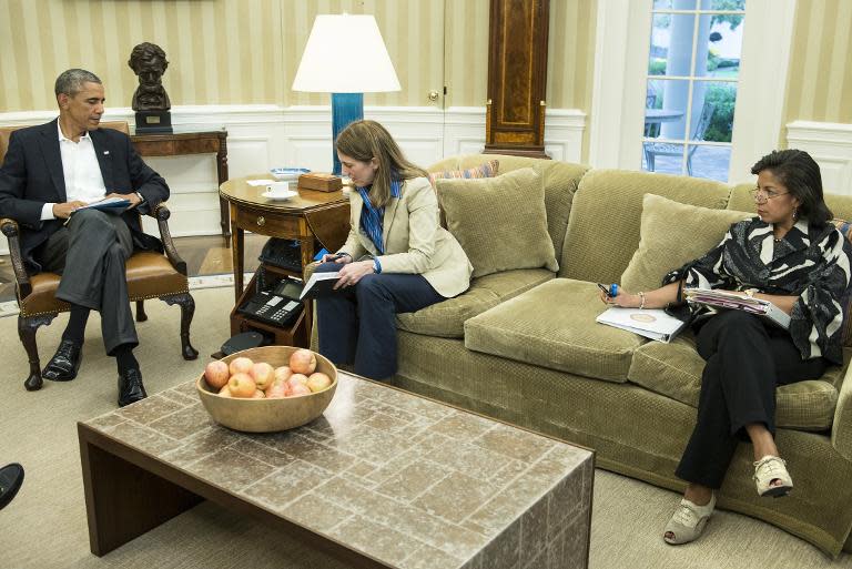 President Barack Obama (L), Health and Human Services Secretary Sylvia Burwell (C)and National Security Advisor Susan Rice, in a call with Tom Frieden, Director of the Centers for Disease Control and Prevention, in the Oval Office October 13, 2014