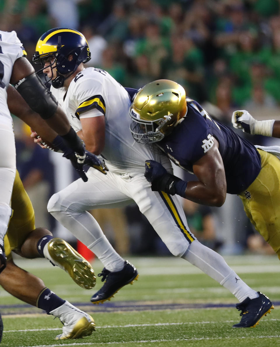 Notre Dame defensive lineman Khalid Kareem (53) sacks Michigan quarterback Shea Patterson (2) in the first half of an NCAA football game in South Bend, Ind., Saturday, Sept. 1, 2018. (AP Photo/Paul Sancya)