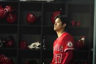 Los Angeles Angels Shohei Ohtani, of Japan, looks out from the dugout before batting in the fifth inning of a baseball game against the Texas Rangers in Arlington, Texas, Monday, May 16, 2022. (AP Photo/LM Otero)