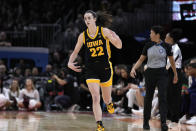 Iowa guard Caitlin Clark celebrates after making a three-point basket during the first half of the Final Four college basketball championship game against South Carolina in the women's NCAA Tournament, Sunday, April 7, 2024, in Cleveland. (AP Photo/Morry Gash)