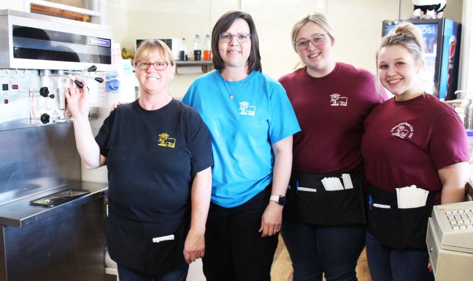 Missi May (second from left), owner of the Dairy Bar Restaurant in Berlin, stands by the soft-serve ice cream machine with some of her staff (from left) Cathy Koontz, Emily Hutchinson and Laura Sines. The new owner plans to discontinue the ice cream end of the business.