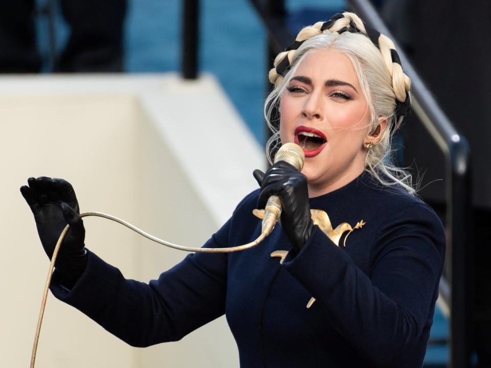 Lady Gaga sings the National Anthem during the inauguration ceremony dressed in a custom Schiaparelli Haute Couture look that featured a gilded dove of peace broochREUTERS