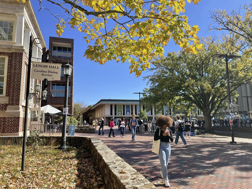 Students walk through the quad outside the student union at the University of North Carolina at Chapel Hill on Monday, Oct. 24, 2022. The U.S. Supreme Court will hear a case on Monday, Oct. 31, over the university's consideration of race in the admissions process. (AP Photo/Hannah Schoenbaum)