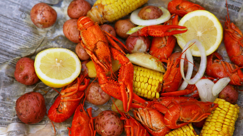 Raw shrimp, red potatoes, corn cobs, and seasonings