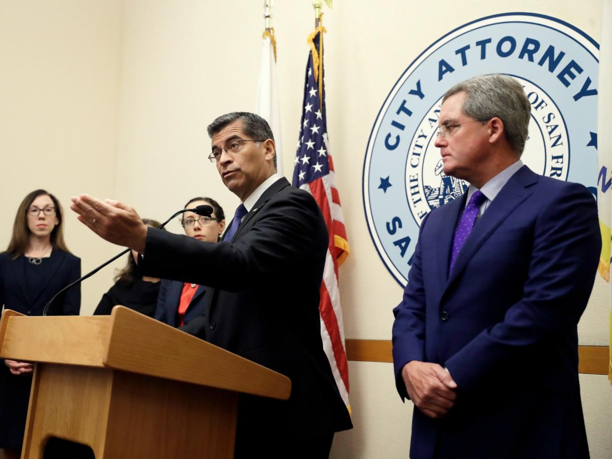 California Attorney General Xavier Becerra and San Francisco City Attorney Dennis Herrera discuss suing the Trump administration over its immigration policies on Monday, Aug. 14, 2017, in San Francisco: AP Photo/Marcio Jose Sanchez