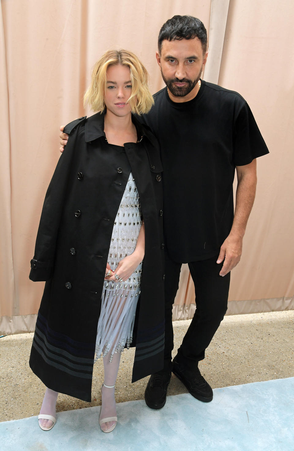 LONDON, ENGLAND - SEPTEMBER 26: Milly Alcock and CCO of Burberry Riccardo Tisci pose backstage at the Burberry Spring/Summer 2023 runway show in Bermondsey on September 26, 2022 in London, England. (Photo by David M. Benett/Dave Benett/Getty Images for Burberry)