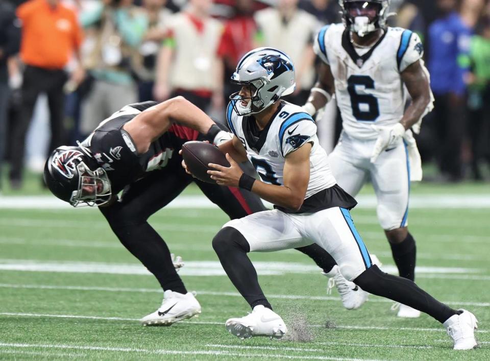 Carolina Panthers quarterback Bryce Young, center, scrambles out of the pocket on a run during fourth-quarter action against the Atlanta Falcons at Mercedes-Benz Stadium in Atlanta, GA on Sunday, September 10, 2023. The Falcons defeated the Panthers 24-10.