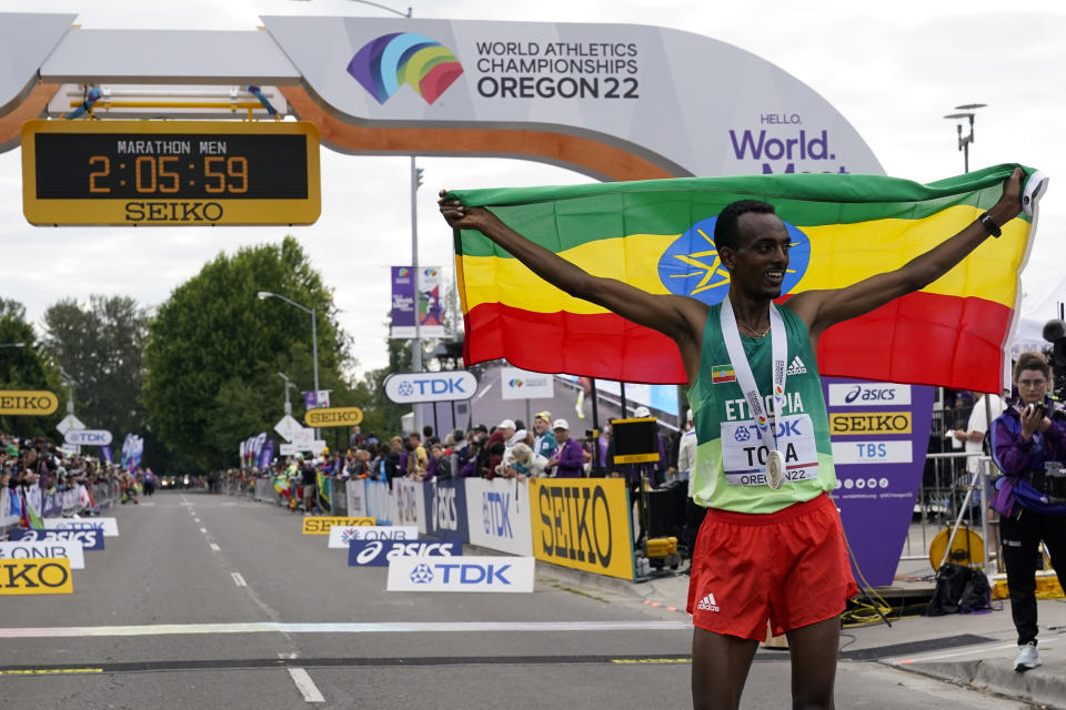 Tamirat Tola, of Ethiopia, celebrates after winning the men's marathon at the World Athletics Championships on Sunday, July 17, 2022, in Eugene, Ore. (AP Photo/Gregory Bull)