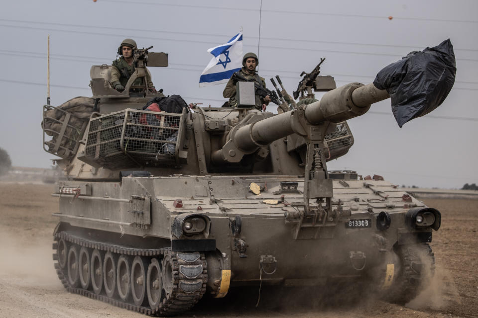 sraeli soldiers on a tank move near the Gaza border on Monday.