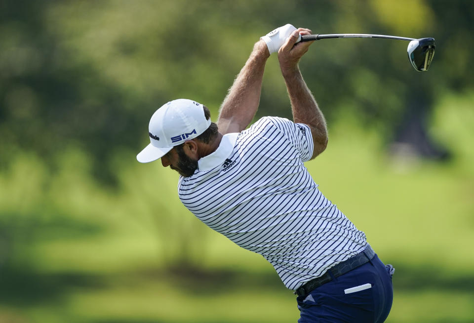 Dustin Johnson hits his tee shot on the fourth hole during the third round of the Tour Championship golf tournament at East Lake Golf Club in Atlanta, Sunday, Sept. 6, 2020. (AP Photo/John Bazemore)