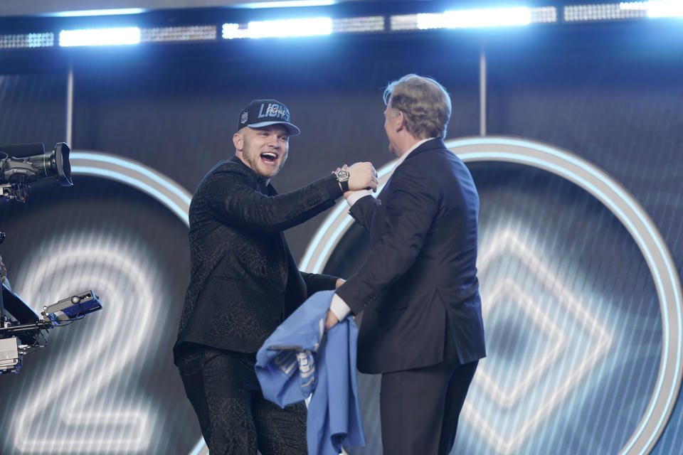 Michigan defensive end Aidan Hutchinson shakes hands with NFL Commissioner Roger Goodell after being selected by the Detroit Lions as the second pick in the NFL football draft Thursday, April 28, 2022, in Las Vegas. (AP Photo/Jae C. Hong )