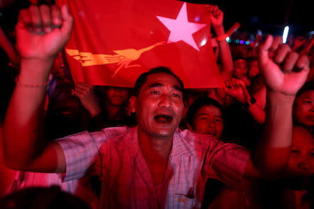 Supporters of Myanmar opposition leader Aung San Suu Kyi celebrate partial results shown on television outside the National League for Democracy (NLD) party headquarters in Yangon November 8, 2015. REUTERS/Soe Zeya Tun