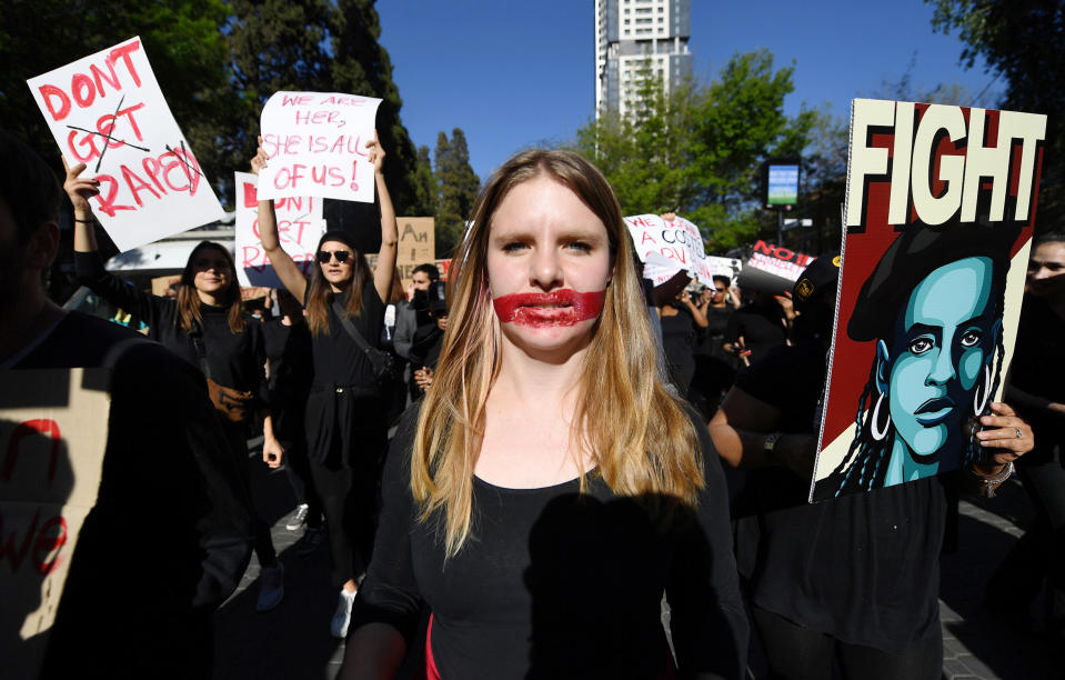 Demonstrators hold up banners in Sandton, Johannesburg, Friday Sept. 13, 2019, as they protest against gender-based violence. The protesters are calling on President Cyril Ramaphosa to declare a state of emergency a day after the country's latest crime statistics were released. (AP Photo)