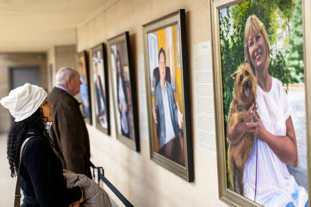 Visitors examine Artist Betsy Ashton's exhibition, "Portraits of Immigrants: Unknown Faces, Untold Stories" at Riverside Church in New York, U.S., March 10, 2019. REUTERS/Demetrius Freeman