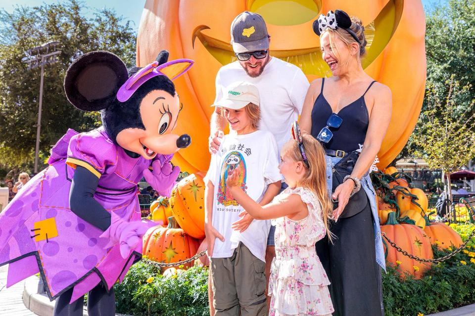 In this handout image provided by Disneyland Resort, actress Kate Hudson and her family celebrate her daughter Rani Rose's birthday with Minnie Mouse during Halloween Time at Disneyland Park on September 26, 2022 in Anaheim, California. Halloween Time casts a spell throughout Disneyland Resort with family-friendly experiences, including Haunted Mansion Holiday, Mickey Mouse pumpkin photos, favorite Cars Land characters dressed up in festive car-stumes and so much more through Oct. 31.