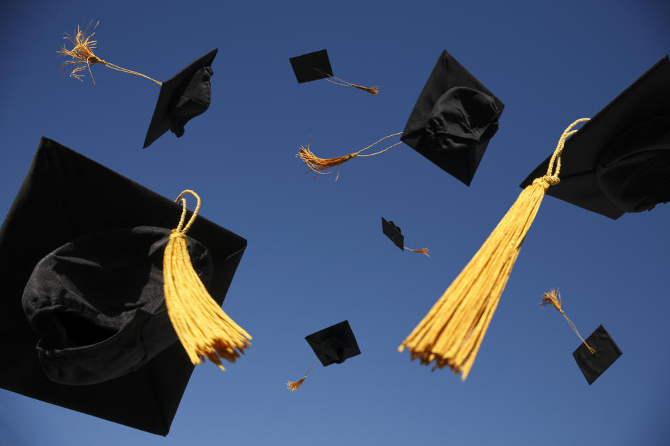 graduation caps thrown in the air