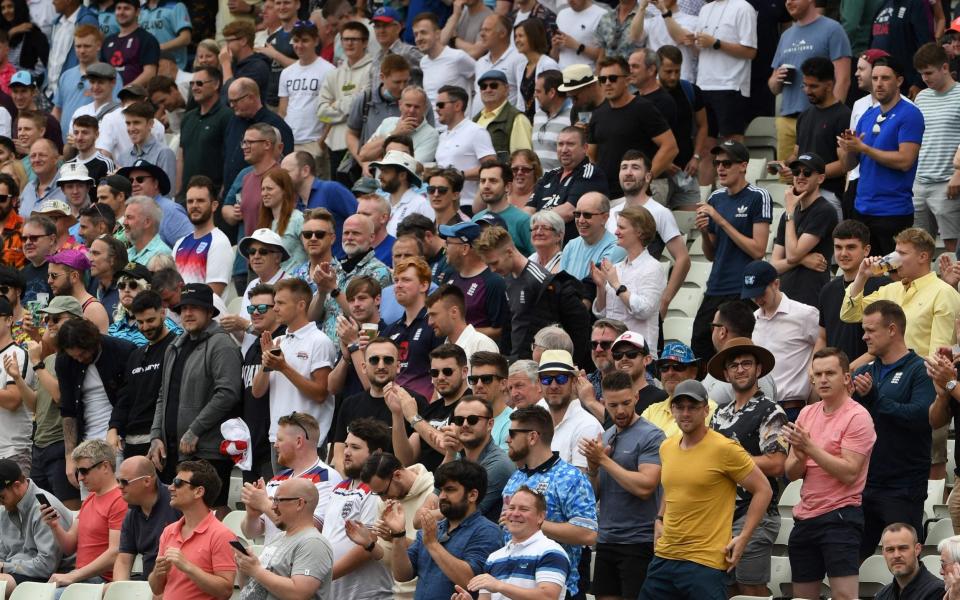 Spectators applaud players as the teams enter the pitch on the first day of the second Test cricket match between England and New Zealand at Edgbaston - PAUL ELLIS/AFP 