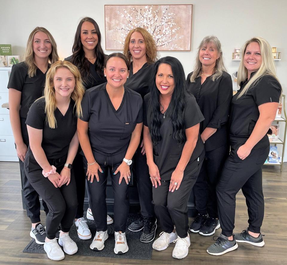 Tarah Jaras, center, and the staff of B. Radiant Wellness, which recently moved to a bigger location at 218 Cambridge Road. It's former spot at 1037 Walnut St. is now B. Radiant Nail Salon.