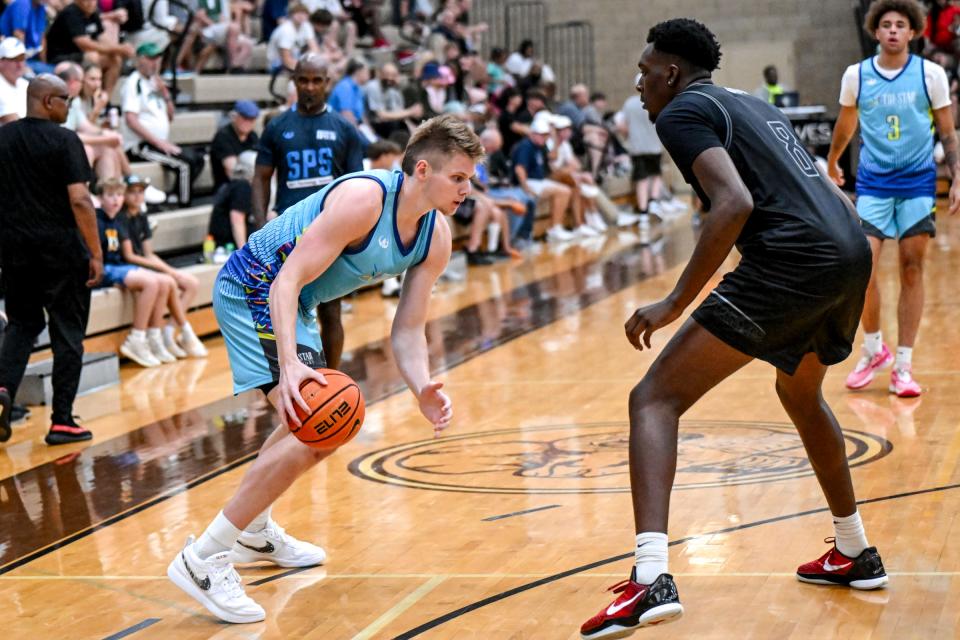 Jaxon Kohler of Michigan State and Team Tri-Star Trust, left, moves the ball as MSU teammate and Team Motorcars teammate Xavier Booker defends in the game on Tuesday, June 25, 2024, during Moneyball Pro-Am at Holt High School.