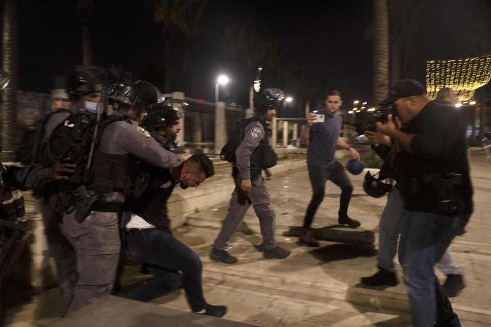 Israeli police detain a Palestinian youth at the Damascus Gate to the Old City of Jerusalem during the Muslim holy month of Ramadan, Saturday, April 24, 2021. Clashes between police and Palestinian protesters here have become a nightly occurrence throughout the Muslim holy month of Ramadan. (AP Photo/Maya Alleruzzo)