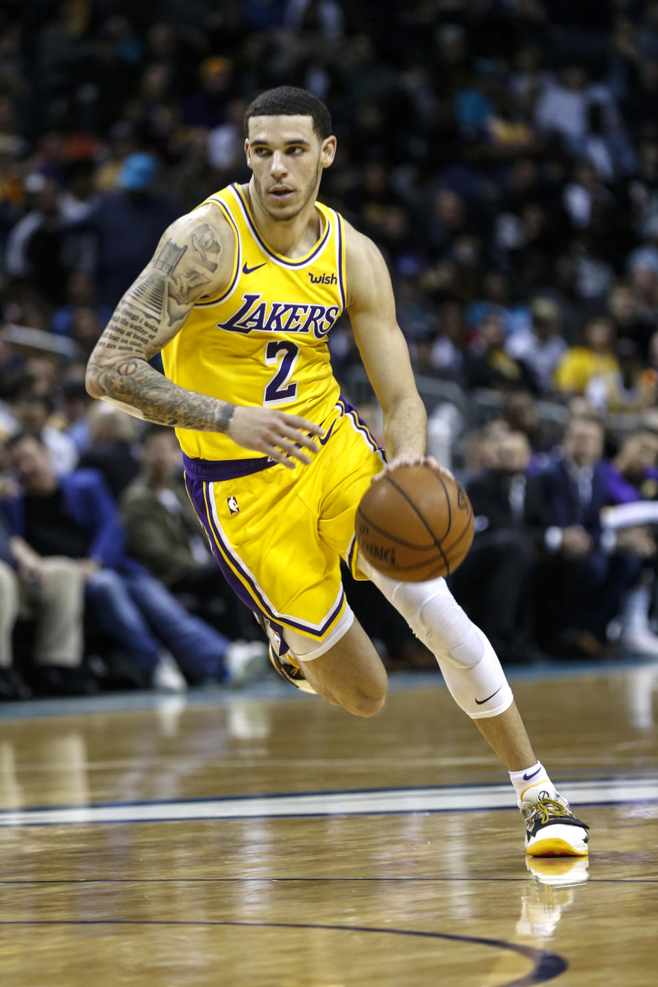 FILE - In this Dec. 15, 2018, file photo, Los Angeles Lakers guard Lonzo Ball runs the offense against the Charlotte Hornets during the second half of an NBA basketball game in Charlotte, N.C. Two people familiar with the situation say the New Orleans Pelicans have agreed to trade six-time All-Star Anthony Davis to the Lakers for Ball, forward Brandon Ingram, shooting guard Josh Hart and three first-round draft choices. The people spoke to The Associated Press on condition of anonymity because the trade cannot become official until the new league year begins July 6. ESPN first reported the trade.(AP Photo/Nell Redmond, File)
