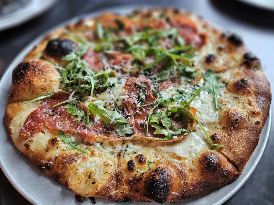 The Farmer & Pig pizza with imported prosciutto, arugula, mozzarella, hot honey, herbed extra-virgin olive oil, and freshly shaved pecorino Romano at the Oak & Stone in downtown Bradenton photographed Jan. 26, 2024.