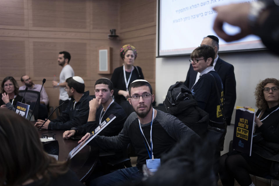 Relatives and supporters of Israelis held hostage by Hamas attend a committee hearing at the Knesset, Israel's parliament, in Jerusalem, Monday, Feb. 5, 2024. Across Israel, the chants of "Now! Now! Now!" ring out at nearly every protest imploring Israel's government to do everything possible to win the immediate release of dozens of hostages held by Hamas in Gaza. But a small group of families of hostages are pushing a different message: let the army first finish the job of defeating the militant group. (AP Photo/Maya Alleruzzo)