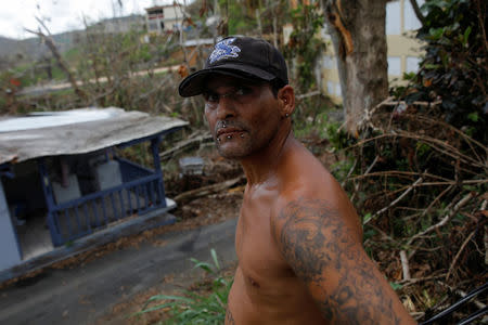 A resident affected by Hurricane Maria stands near his home in the Trujillo Alto municipality outside San Juan, Puerto Rico, October 9, 2017. REUTERS/Shannon Stapleton