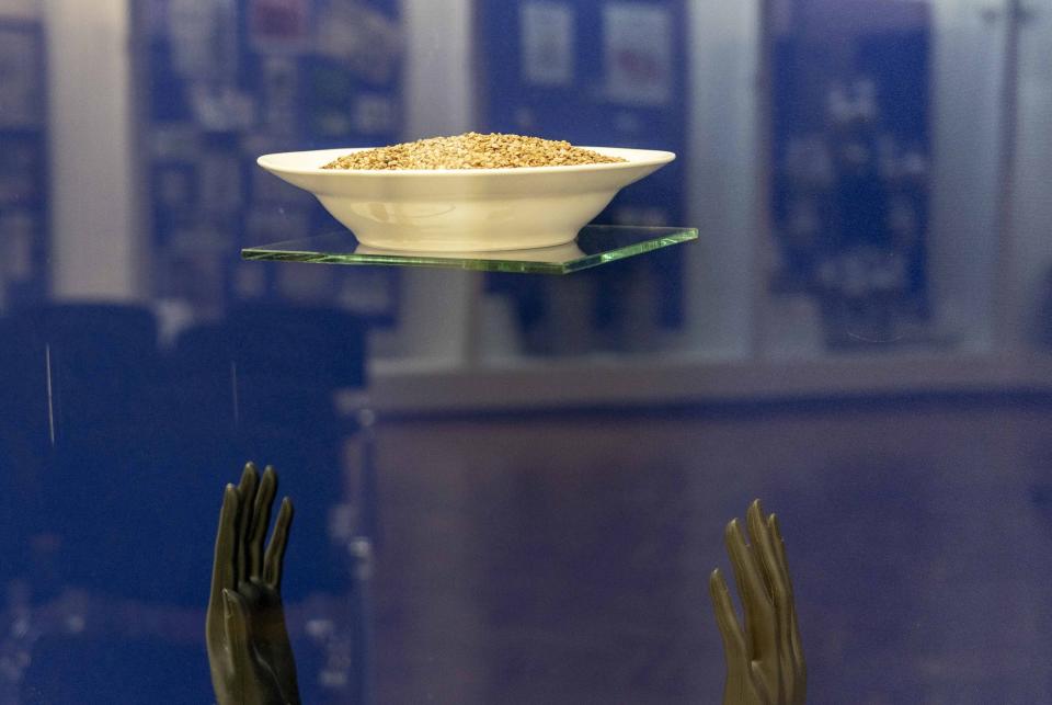 In this photo taken on Friday, July 12, 2019, a bowl of buckwheat is displayed in an exhibition at the National History Museum, in Kiev, Ukraine. A Darth Vader costume, playground equipment, pastries and boxes of food all are part of an exhibit at Ukraine’s National History Museum displaying the colorful behavior and sometime-questionable practices that characterize the country’s elections. The exhibition, called “The Museum of Election Trash” was put together ahead of the snap parliamentary elections on Sunday, July 21, 2019. (AP Photo/Evgeniy Maloletka)