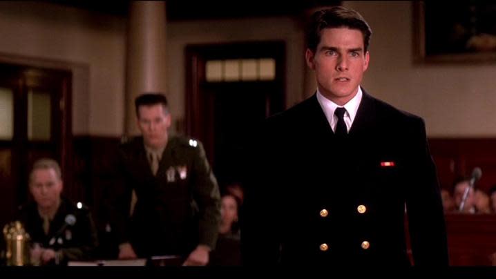 Tom Cruise stands in front of the courtroom. 