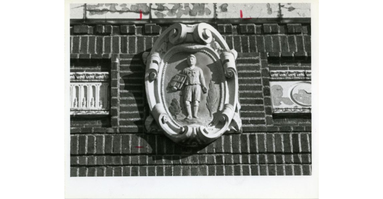 Photograph of a terra cotta medallion architectural detail on the exterior front of Rankin School, 415 Storer Avenue, depicting a schoolboy. There was also one depicting a schoolgirl. The school opened in March of 1926 and was closed in 2012.