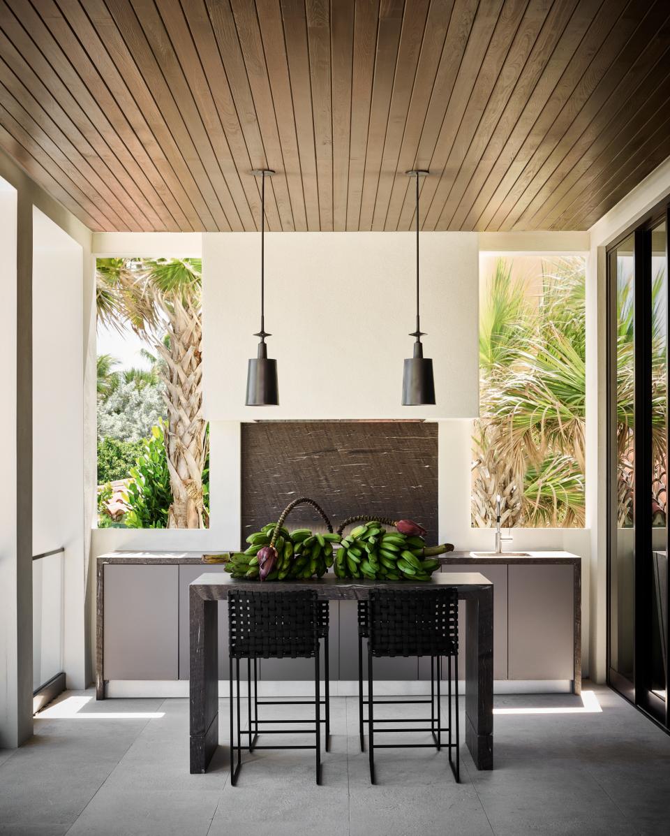 “He said he wanted the coolest outdoor kitchen,” says Wecselman of Joyner. Her design allows him to cook at his Rockwell by Caliber grill while enjoying his private beachfront views. Wecselman custom designed a table and paired it with counter stools by Mark Albrecht Studio, sourced from Holly Hunt.