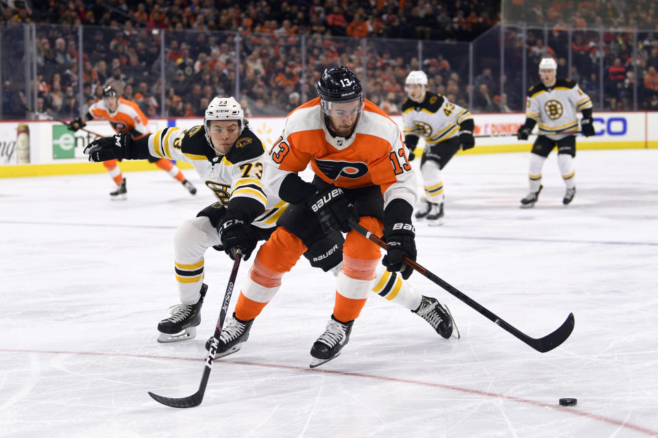 Philadelphia Flyers' Kevin Hayes, right, keeps the puck from Boston Bruins' Charlie McAvoy during the second period of an NHL hockey game, Monday, Jan. 13, 2020, in Philadelphia. (AP Photo/Derik Hamilton)